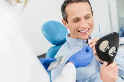 man choosing which color dental veneers he would like