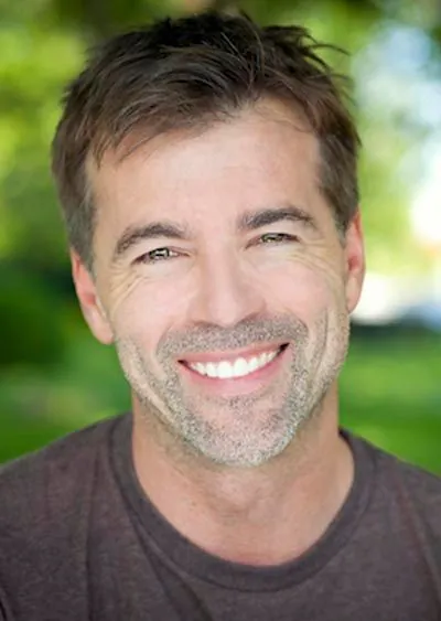 man smiling big after having his smile restored at Brite Dental Partners
